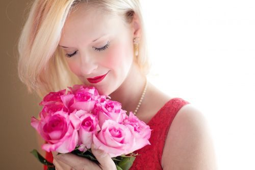 Woman Smelling Fragrant Roses