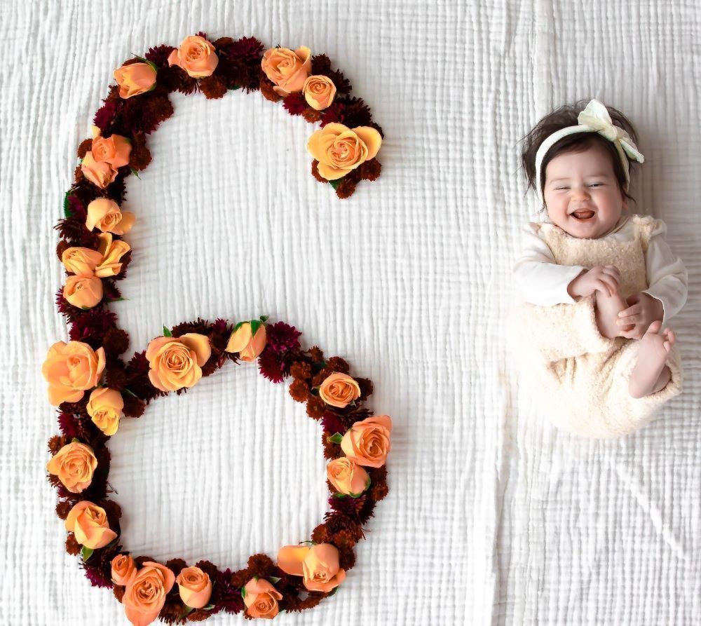 6 Month Old Girl With Orange Roses