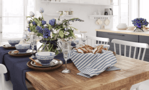 A table is set with blue and white plates and cups.