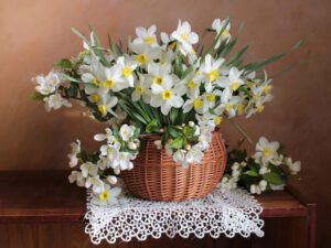 Daffodils in a wicker basket on a table.